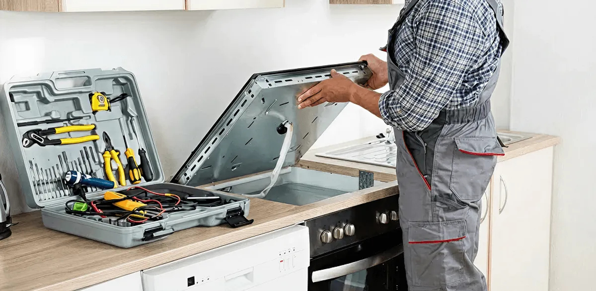 Handyman repairing a cooktop and checking wiring connections in Fort Worth, TX