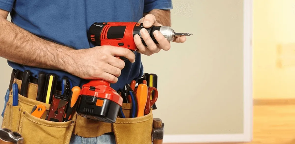 Handyman holding a power drill for home repairs and installations in Fort Worth, TX